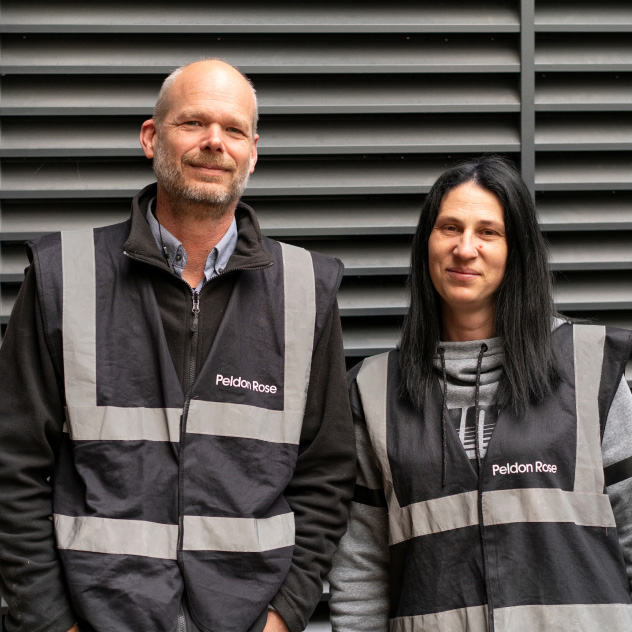 Two Peldon Rose employees in black safety vests