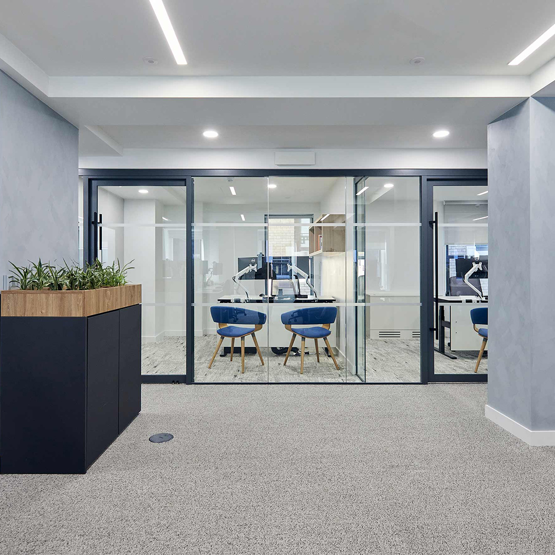 Sleek office interior design with glass wall meeting rooms and desk, perfect for meetings and productivity