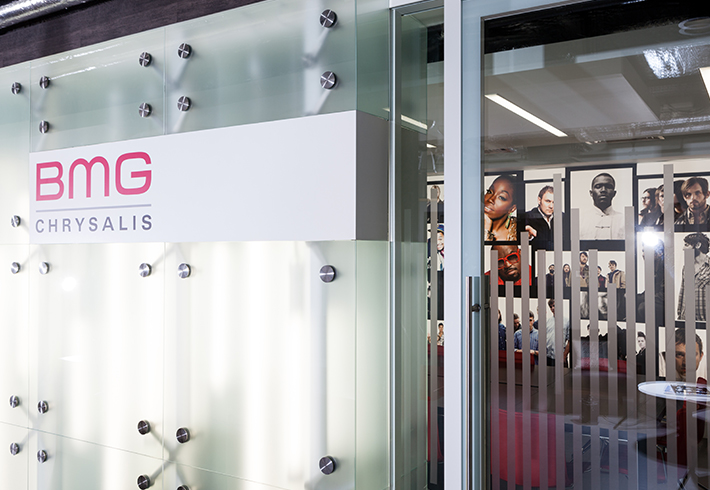 glass door and wall with seating area and company logo