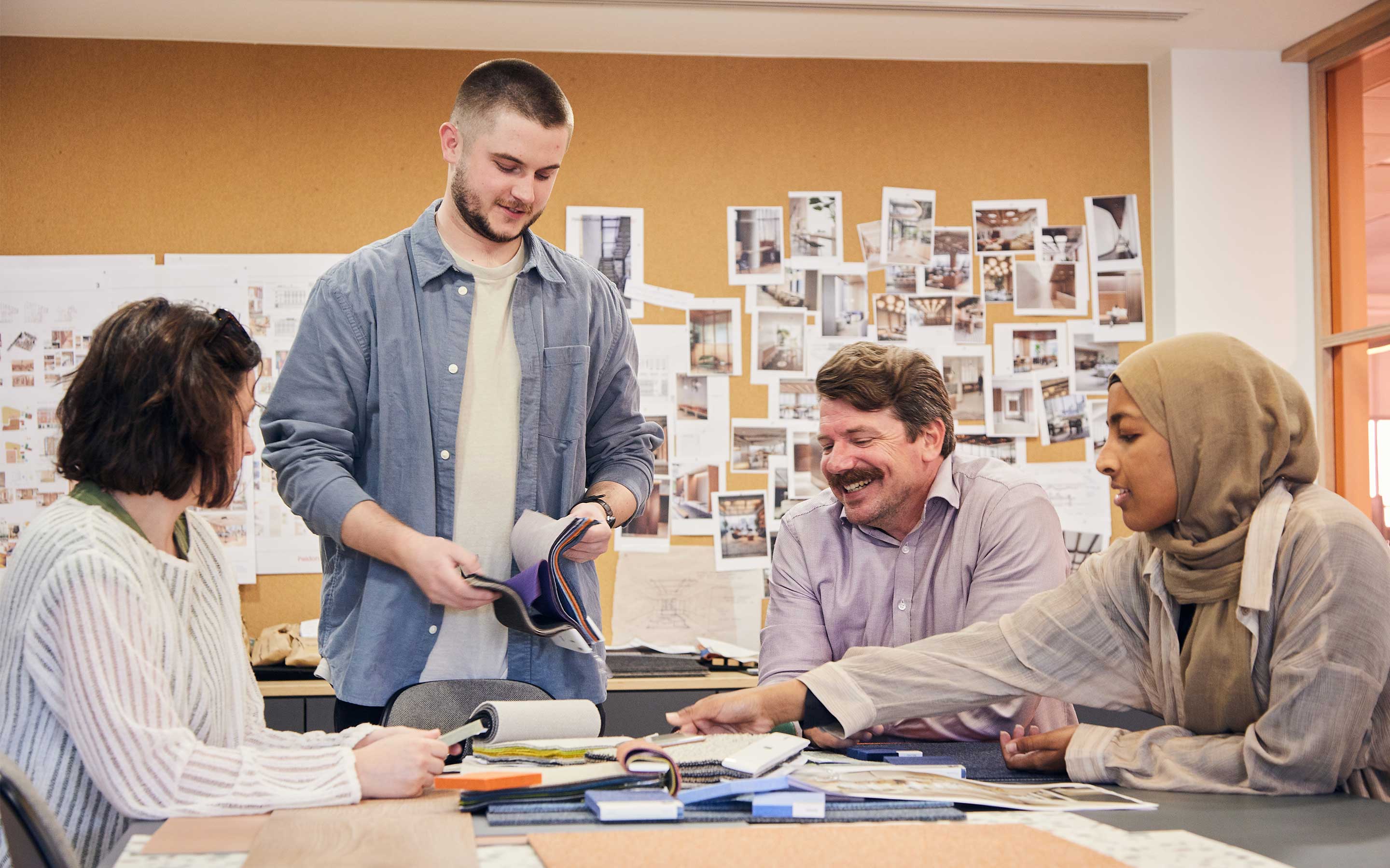 Colleague collaborate about interior design in a bright studio, enjoying each other's company