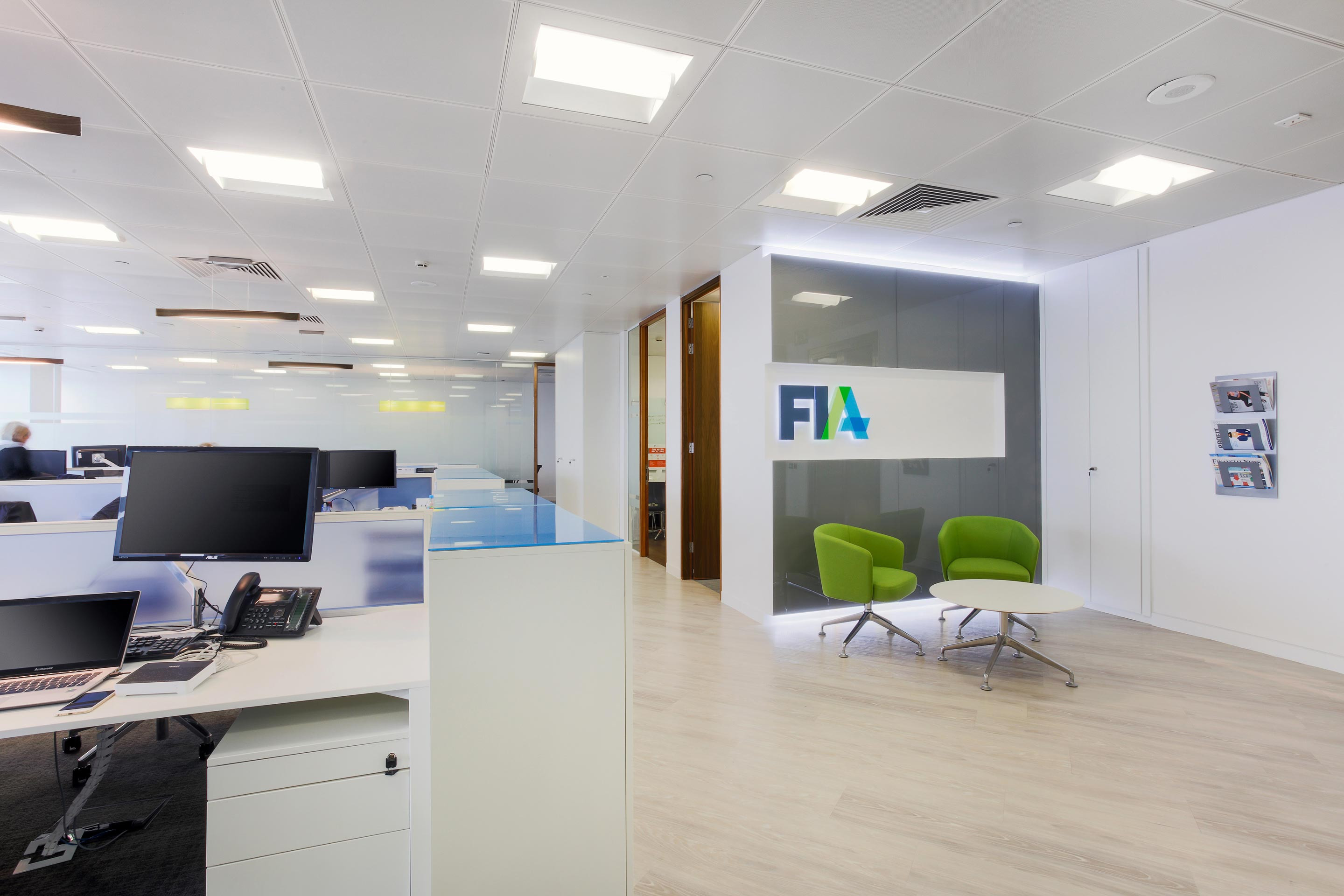 white workstations and a feature wall in an open office space